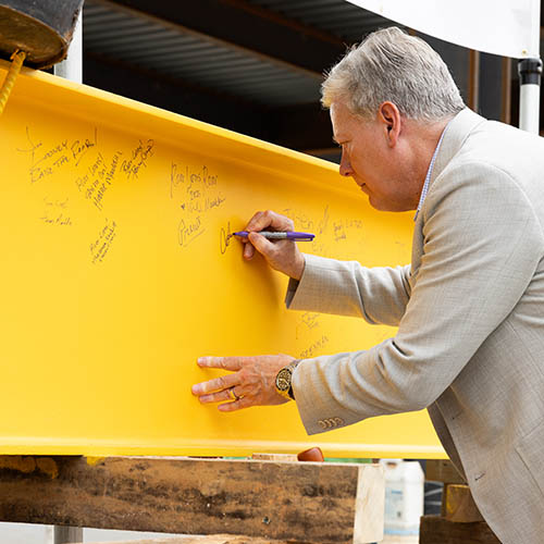 executive signing beam