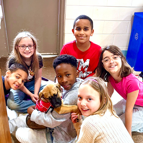child hugging leo mascot in front of kilby